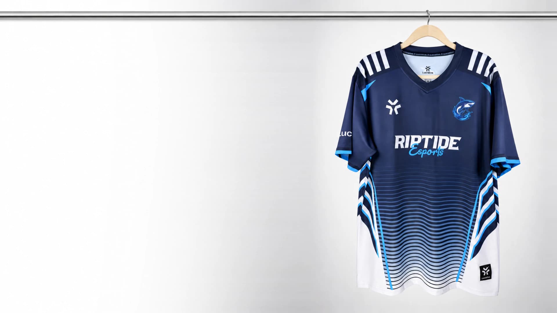 Navy, blue and white Riptide Esports jersey hanging on a rail